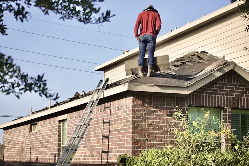 Professional roofer working on a residential roof in Hiawatha Woods